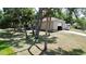 Large outbuilding with an RV parked alongside on a well-manicured, treed lot at 14057 Maxwell Ave, Port Charlotte, FL 33953