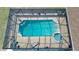 Aerial view of a screened-in pool and spa with ample deck space for outdoor relaxation at 14057 Maxwell Ave, Port Charlotte, FL 33953