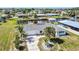 Single-story home with a well-maintained lawn, mature palms, and a canal view with dock at 148 Salem Nw Ave, Port Charlotte, FL 33952