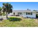 Well-kept single-story home featuring a tidy lawn, established landscaping, and an attached garage at 148 Salem Nw Ave, Port Charlotte, FL 33952