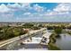 Aerial view of the community pool area, with lake views, surrounding landscape, and ample parking at 25225 Rampart Blvd # 1701, Punta Gorda, FL 33983