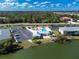 Aerial view of community amenities, pool, and lakefront property at 25225 Rampart Blvd # 1701, Punta Gorda, FL 33983