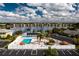 Aerial view highlighting the community pool, lakefront location, and surrounding residential area at 25225 Rampart Blvd # 1701, Punta Gorda, FL 33983