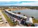 Aerial view of condo complex on a lake surrounded by lush landscaping and parking at 25225 Rampart Blvd # 1701, Punta Gorda, FL 33983