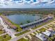 Aerial view overlooking condo community on a scenic lake, surrounded by lush trees at 25225 Rampart Blvd # 1701, Punta Gorda, FL 33983