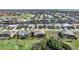 Aerial view of a residential neighborhood, a river, and a golf course in a lush environment at 3977 La Costa Island Ct, Punta Gorda, FL 33950