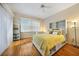Cozy bedroom featuring wood floors, neutral walls, large windows, and white furnishings at 3977 La Costa Island Ct, Punta Gorda, FL 33950