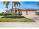 Beautiful single-Gathering home with barrel tile roof, columned entryway, paver driveway and a two-car garage at 3977 La Costa Island Ct, Punta Gorda, FL 33950