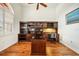 Bright home office boasts wood floors, large built-in bookshelves, a large window, and vaulted ceilings at 3977 La Costa Island Ct, Punta Gorda, FL 33950