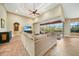 Comfortable living room with neutral walls, tile flooring, a ceiling fan and a sliding glass door to the lanai at 3977 La Costa Island Ct, Punta Gorda, FL 33950