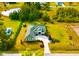 Stunning aerial view of a beautiful home featuring lush landscaping and a long private driveway at 500 Woodstork Ln, Punta Gorda, FL 33982