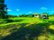 Expansive backyard featuring well-maintained lawn, a canopy, and ample room for outdoor activities and relaxation at 500 Woodstork Ln, Punta Gorda, FL 33982
