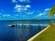 A private dock extends into the blue water, offering direct access for boating and stunning water views at 500 Woodstork Ln, Punta Gorda, FL 33982