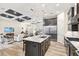 Open floor plan showcasing kitchen island, stainless appliances, and view of living room with coffered ceiling at 500 Woodstork Ln, Punta Gorda, FL 33982