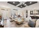 Spacious living room featuring tile floors, modern furniture, a coffered ceiling, and an open floor plan at 500 Woodstork Ln, Punta Gorda, FL 33982