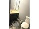 Cozy bathroom with a unique patterned floor mat, toilet, and a vanity with shuttered doors at 1174 Victoria Ave, Port Charlotte, FL 33948