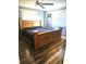 Bedroom featuring a large bed with a wooden frame, carpeted floors, and natural lighting at 1174 Victoria Ave, Port Charlotte, FL 33948