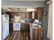 Kitchen with wood-look cabinets and countertops, complemented by modern appliances and ample lighting at 1174 Victoria Ave, Port Charlotte, FL 33948