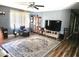 Spacious living room with a large rug, ceiling fan, and entertainment center at 1174 Victoria Ave, Port Charlotte, FL 33948