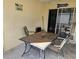 Outdoor patio with a dining table, chairs, and sliding glass doors leading to the interior at 1174 Victoria Ave, Port Charlotte, FL 33948
