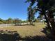 Spacious backyard features a white picket fence and mature trees at 1438 Navigator Rd, Punta Gorda, FL 33983