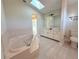 This bright bathroom is complete with bathtub, vanity, and skylight at 1438 Navigator Rd, Punta Gorda, FL 33983
