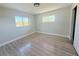 A bright bedroom with two windows and laminate flooring at 1438 Navigator Rd, Punta Gorda, FL 33983