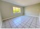 A minimalist bedroom with a large window that offers natural light at 1438 Navigator Rd, Punta Gorda, FL 33983