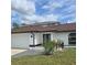 Charming one-story home with a well-manicured lawn, double door entry, and an attached two car garage at 1438 Navigator Rd, Punta Gorda, FL 33983