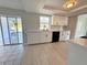 Updated kitchen featuring white cabinets, black hardware, stainless steel appliances and access to the lanai at 1438 Navigator Rd, Punta Gorda, FL 33983
