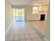 Bright kitchen with white cabinets, black appliances, and sliding glass doors to the outdoor area at 1438 Navigator Rd, Punta Gorda, FL 33983