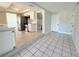Open-concept kitchen with stainless steel appliances, white cabinetry, tile backsplash, and access to the dining area at 1438 Navigator Rd, Punta Gorda, FL 33983