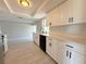 Updated kitchen featuring white cabinetry, black hardware, tiled backsplash, and stainless steel appliances at 1438 Navigator Rd, Punta Gorda, FL 33983