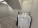 Cozy laundry room with tile floor and a white washing machine at 1438 Navigator Rd, Punta Gorda, FL 33983