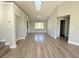Large living room featuring hardwood floors, neutral paint, skylight, and an open layout leading to other rooms at 1438 Navigator Rd, Punta Gorda, FL 33983