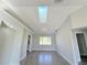 Open-concept living room with hardwood flooring, neutral paint, a skylight, and easy access to other rooms at 1438 Navigator Rd, Punta Gorda, FL 33983