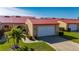 Charming villa with a vibrant red roof, well-manicured lawn, and attached garage at 1780 Deborah Dr # 15, Punta Gorda, FL 33950