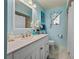 Bright and cheery bathroom with a vanity, an enclosed shower, and stylish blue accents at 18147 Cadillac Ave, Port Charlotte, FL 33948