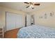 Spacious bedroom with a large closet, a double bed with ocean-themed linens, and hardwood floors at 18147 Cadillac Ave, Port Charlotte, FL 33948