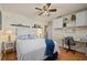 Well-lit bedroom with a white bed, decorative accents, and a work desk with overhead storage at 18147 Cadillac Ave, Port Charlotte, FL 33948