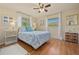 Cozy bedroom with bright windows, hardwood floors, and a bed with sea-themed linens at 18147 Cadillac Ave, Port Charlotte, FL 33948
