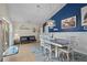 Cozy dining area with modern furniture, a blue accent wall, and direct access to the outdoor living space at 18147 Cadillac Ave, Port Charlotte, FL 33948