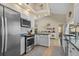 Bright kitchen with stainless steel appliances, white cabinets, and an open design that connects to the dining area at 18147 Cadillac Ave, Port Charlotte, FL 33948