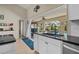 Spacious kitchen area with white cabinets, black countertops, and an open view of the pool and backyard at 18147 Cadillac Ave, Port Charlotte, FL 33948