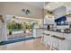 Contemporary kitchen with white cabinetry, a breakfast bar, and access to a covered patio with a pool view at 18147 Cadillac Ave, Port Charlotte, FL 33948