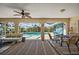 Bright lanai with ceiling fan, outdoor furniture, and view of the screened-in pool at 18147 Cadillac Ave, Port Charlotte, FL 33948