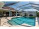 Beautiful screened-in in-ground pool with sun deck and outdoor entertainment area at 18147 Cadillac Ave, Port Charlotte, FL 33948
