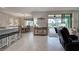 Well-lit dining area with a view to the screened lanai and adjacent to the kitchen at 24109 Spartina Dr, Venice, FL 34293