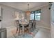 Bright dining room featuring a modern table, decorative rug, and stylish lighting at 24109 Spartina Dr, Venice, FL 34293