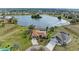 Aerial view of home featuring two driveways and lake view at 1115 Venture Ct, Punta Gorda, FL 33983